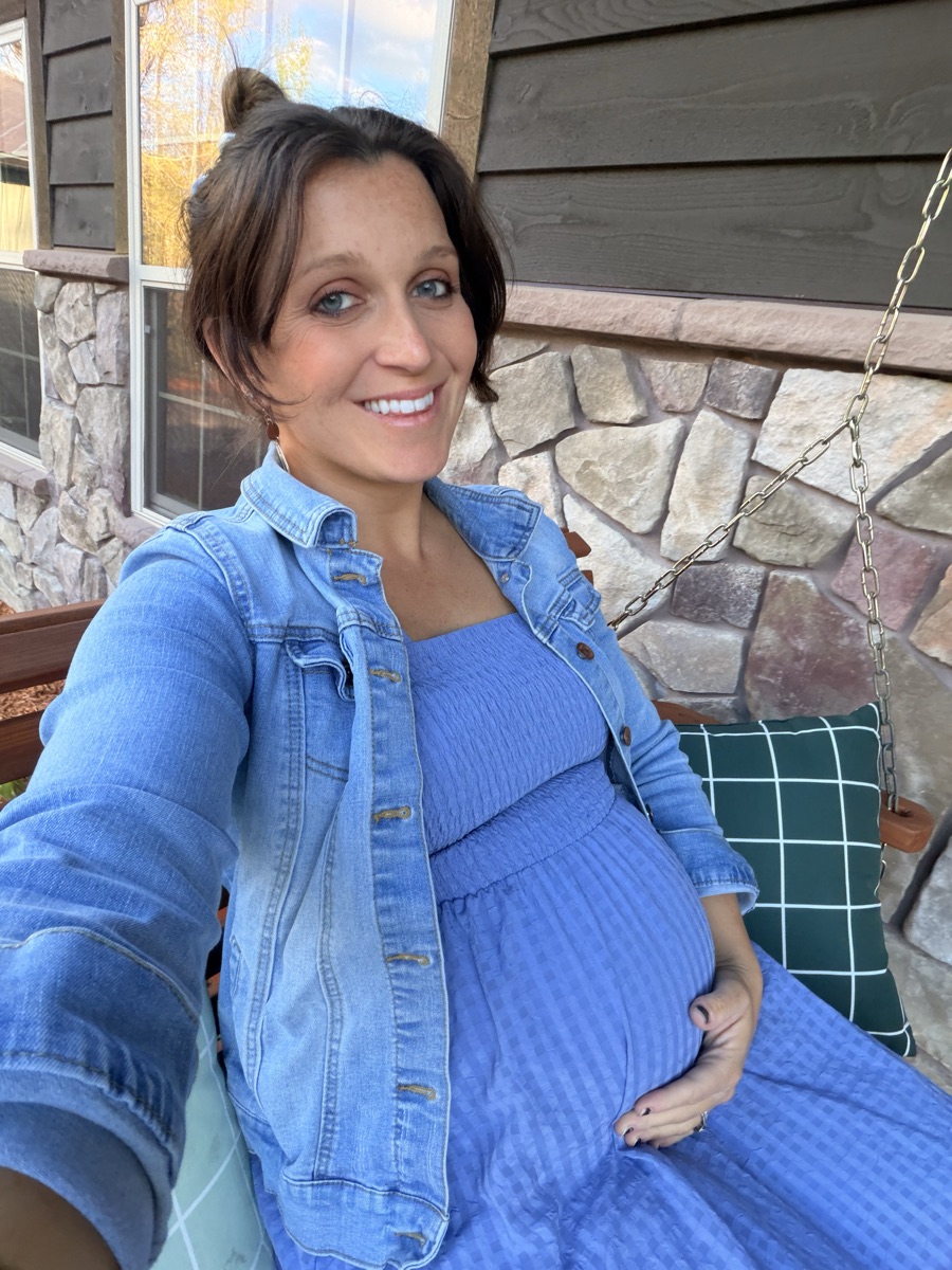Rachel smiling on her front porch swing