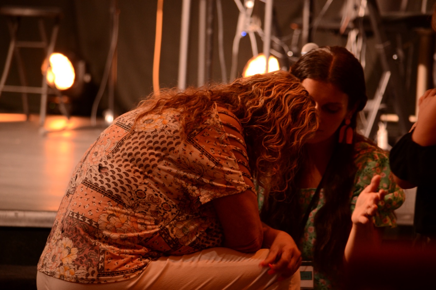 Two women bowed together in prayer
