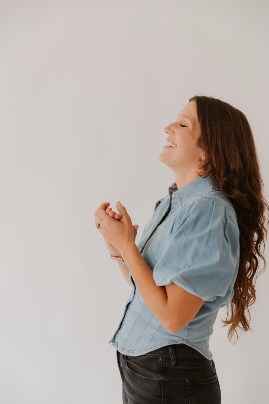 Rachel Lynn Lawrence laughing with her hands clasped