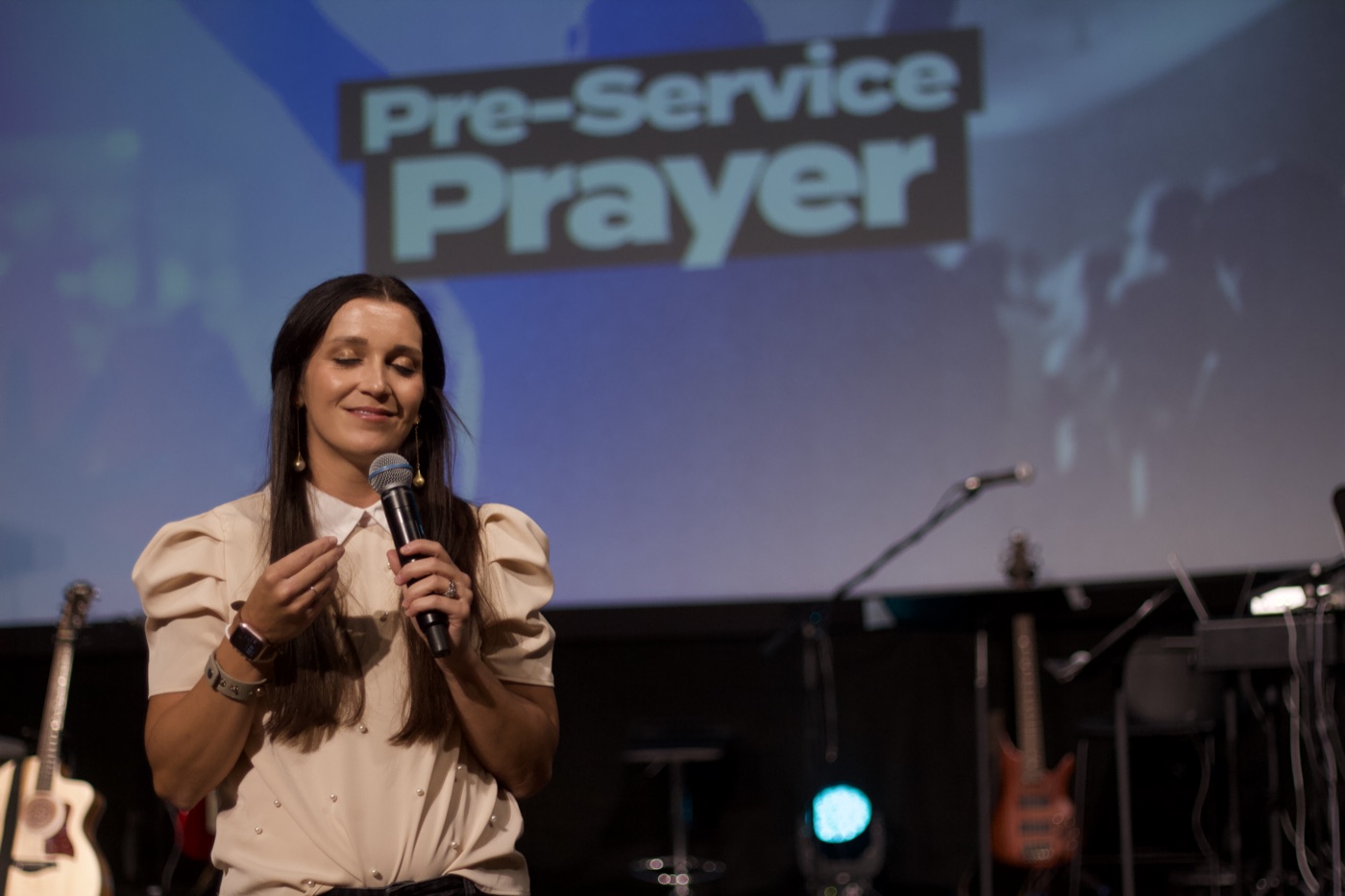 Rachel smiling as she leads a time of prayer